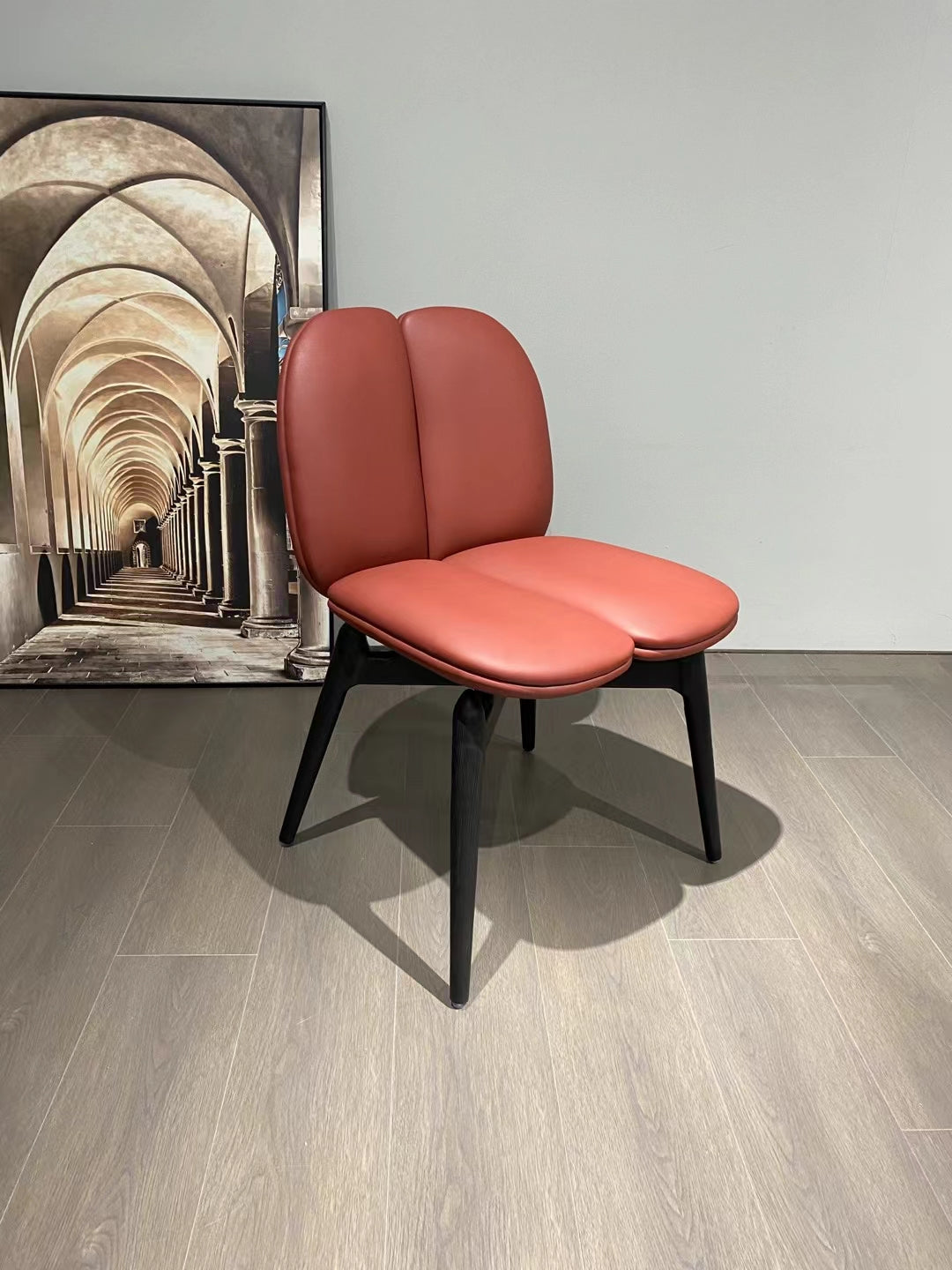 Modern Double-Lobed Leather Chair – Vibrant Orange-Red Upholstery with Black Tapered Legs – Contemporary Lounge Seating