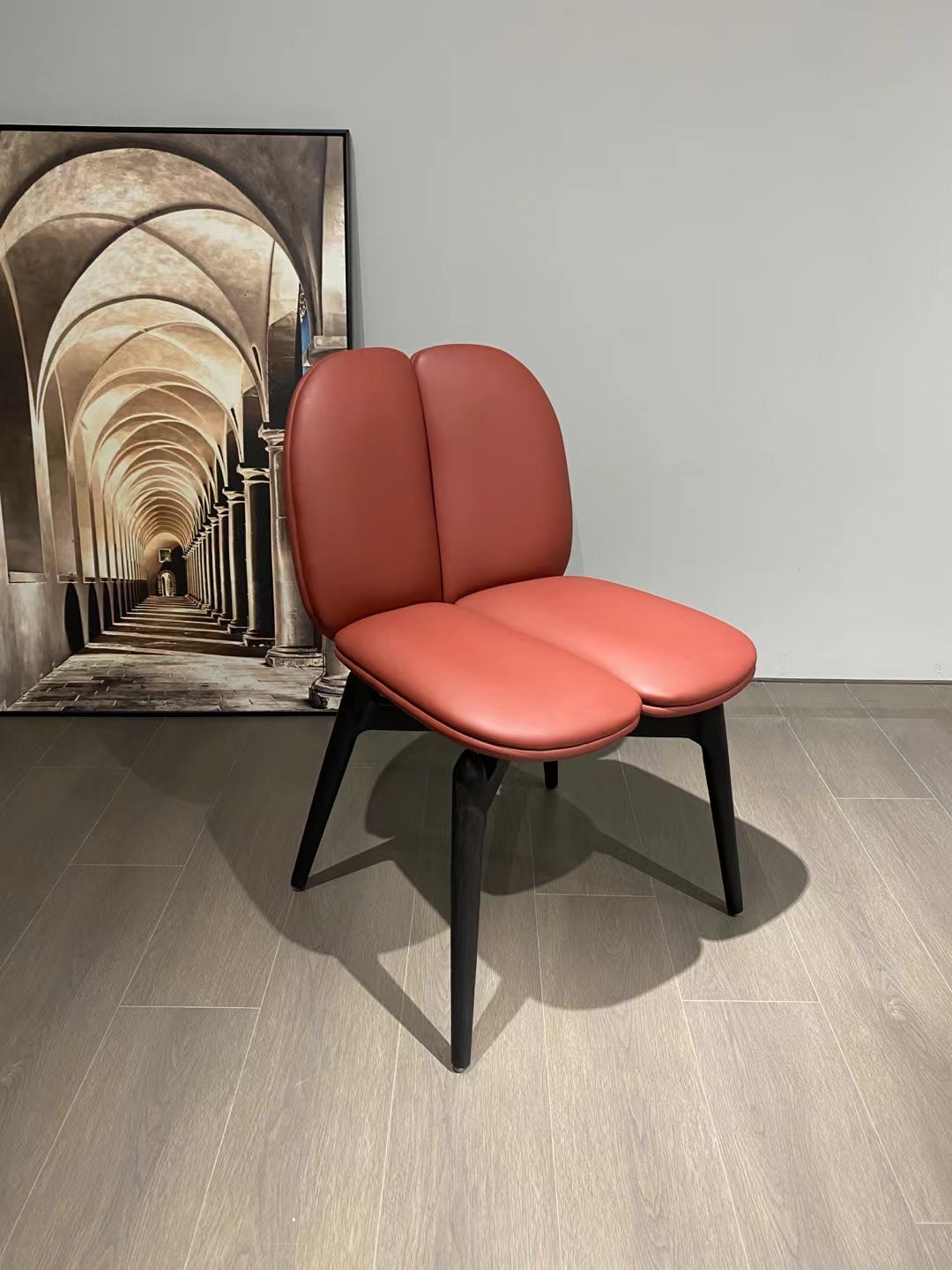 Modern Double-Lobed Leather Chair – Vibrant Orange-Red Upholstery with Black Tapered Legs – Contemporary Lounge Seating